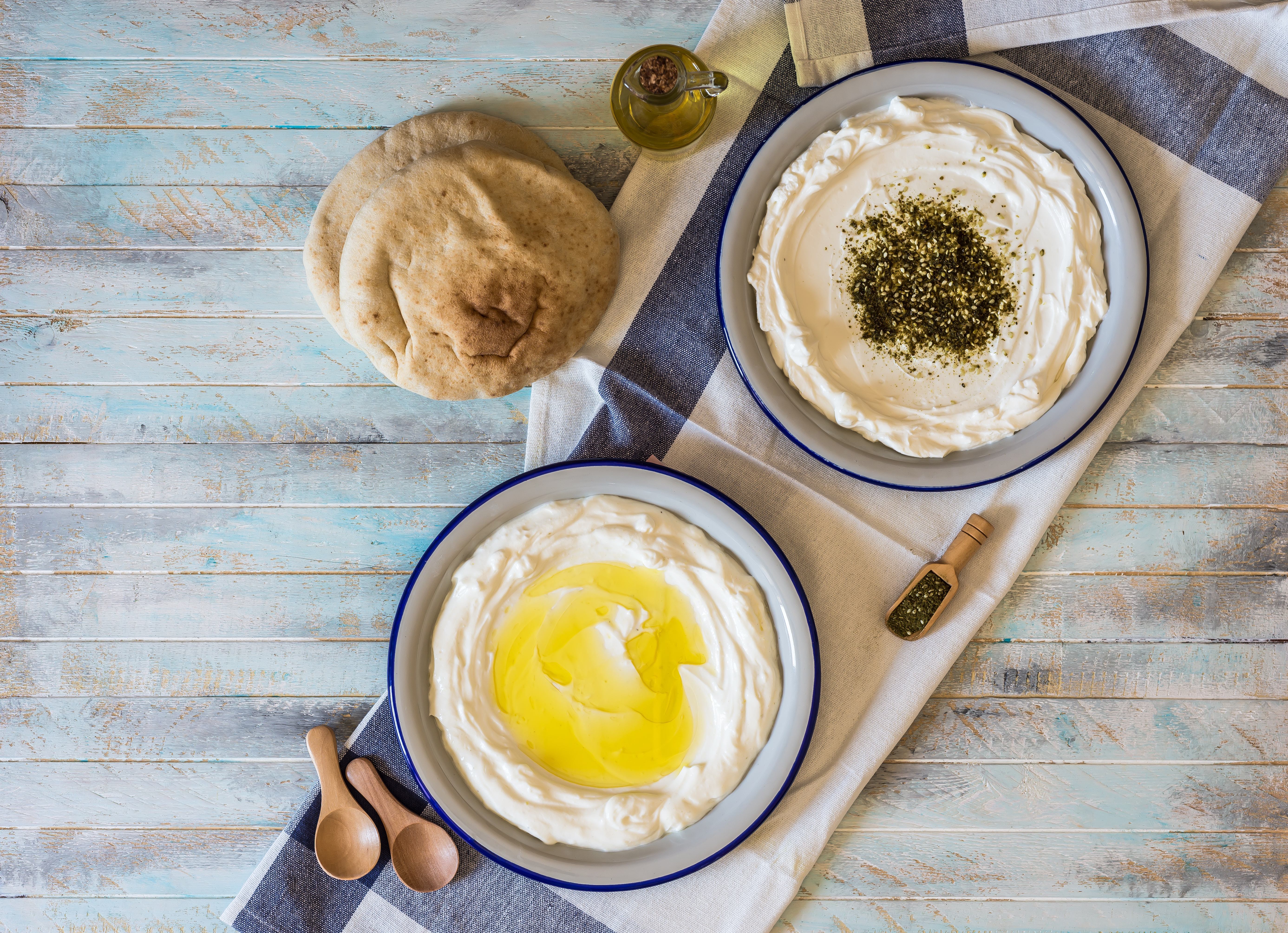 Labneh, olive oil, za'atar and pita on a table
